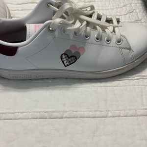 Adidas Stan Smith sneakers with hearts.